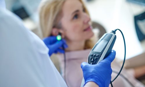 cropped-photo-medical-professional-disposable-sterile-gloves-performing-audiometry-test-blonde-woman