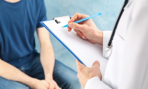 doctor-writing-prescription-in-empty-tablet-consu-2021-09-02-21-43-23-utc