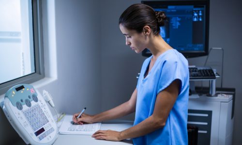 nurse-taking-notes-x-ray-room